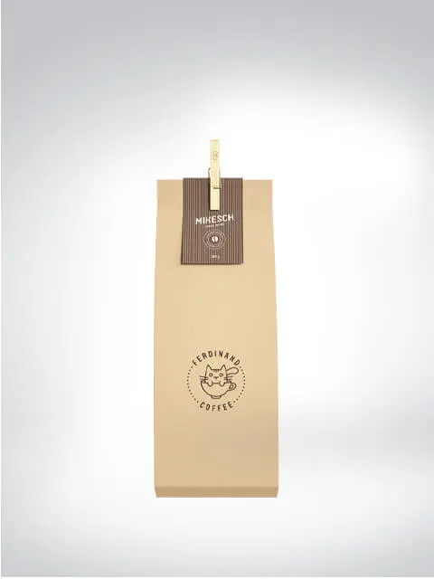 Beige Kaffeeverpackung von Ferdinand Coffee mit einem Katzenlogo und der Aufschrift 'Mikesch'