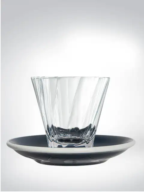 Elegant drinking glass on black coaster, suitable for stylish table decoration or as a gift