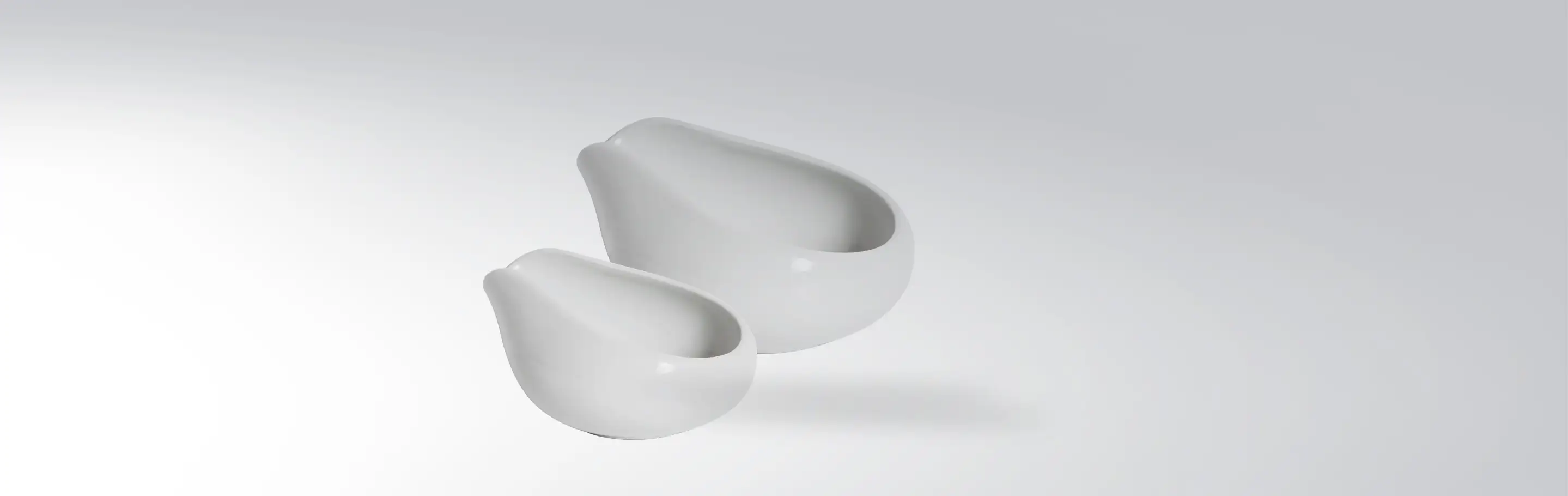 Two white, modern designed bowls in different sizes