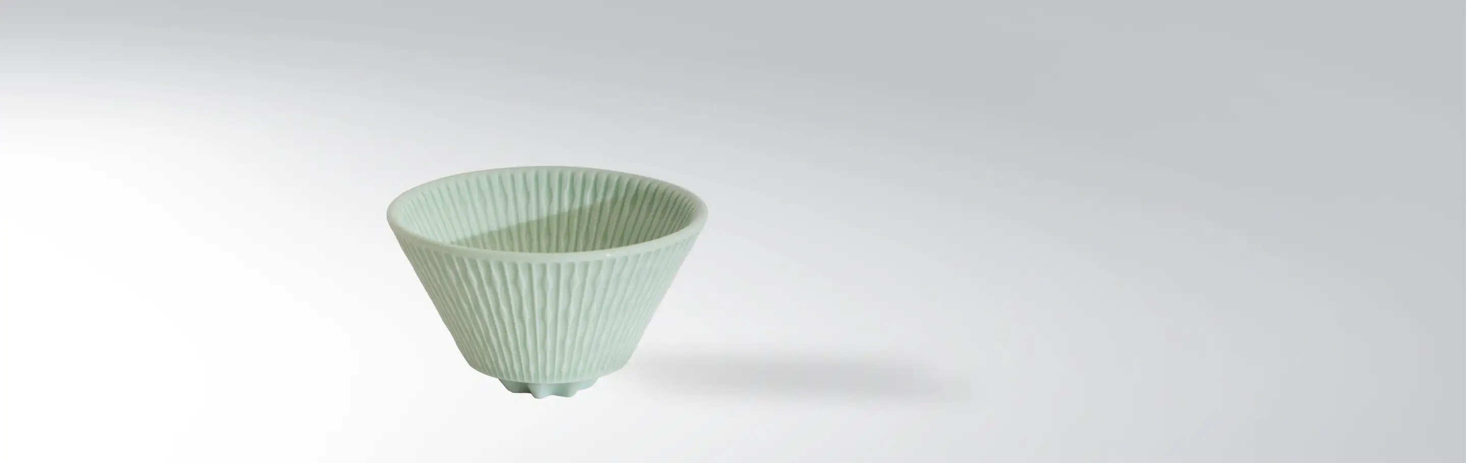 Light green ceramic bowl with ribbed design