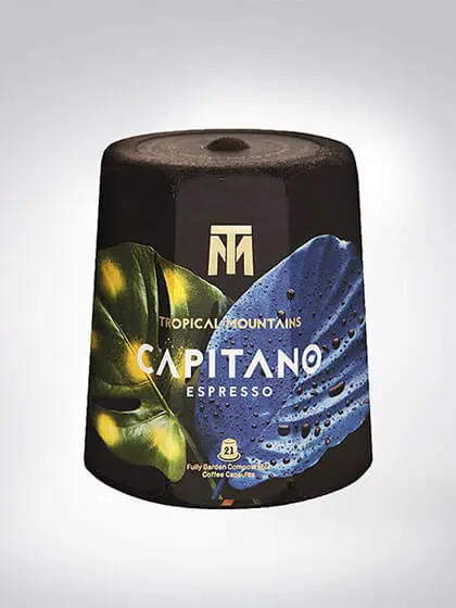 Verpackung von Tropical Mountains Capitano Espresso mit 21 Kaffeekapseln, verziert mit tropischen Blättern in Blau und Grün